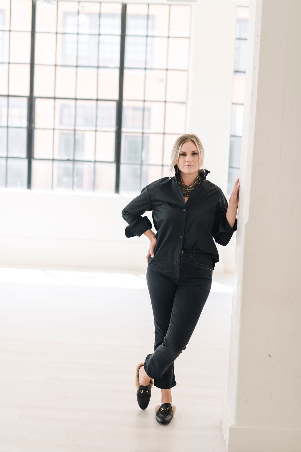 Black long sleeve button up shirt with a ruffle collar and large cuffs.  Tie in a knot, tuck it in or wea untucked for a more casual look.