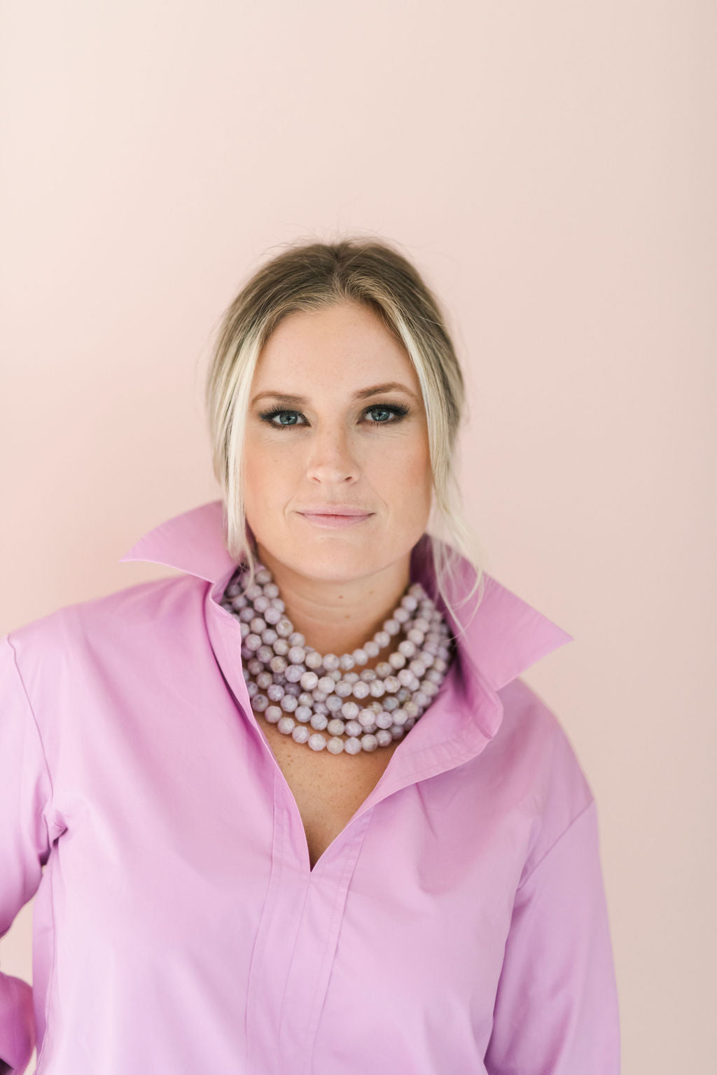 Lilac color, crisp long sleeve shirt with a popped collar, pullover style.