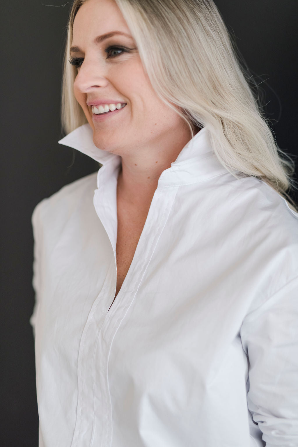 White, crisp long sleeve shirt with a popped collar.
