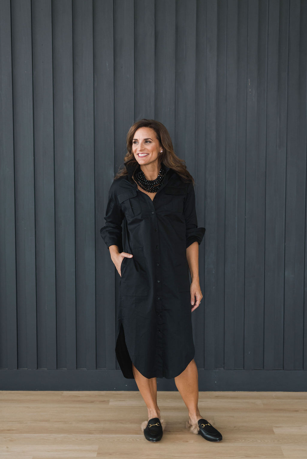 Crisp and classic black button down shirt dress. Mid length, pockets, popped collar.