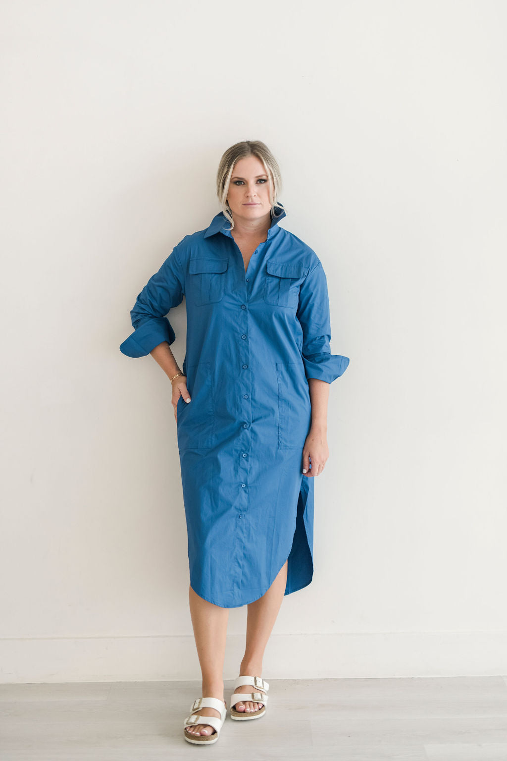 Button down shirt dress in a beautiful blue hue. Features pockets and a popable collar.