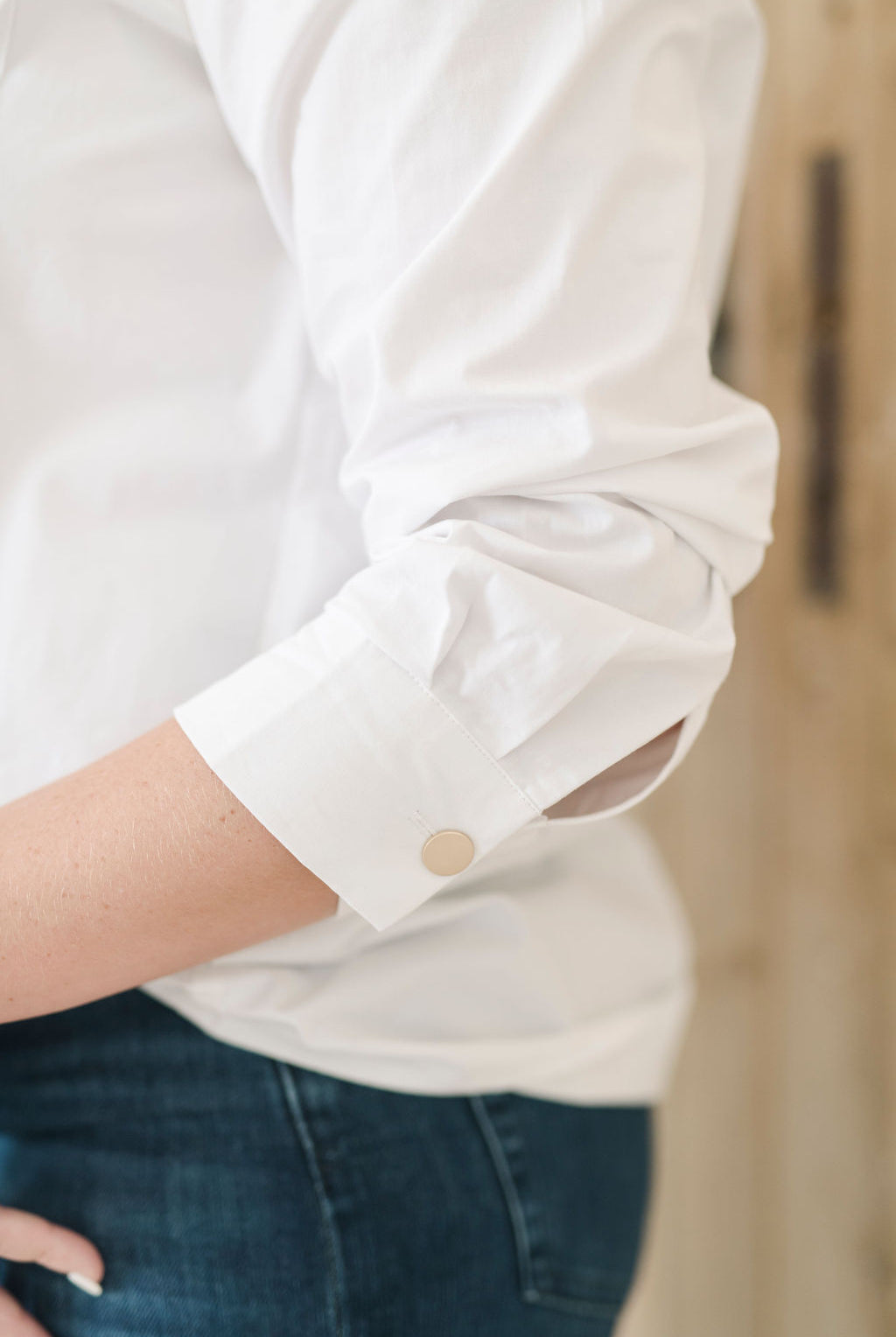 Women's white safari style button up shirt with gold buttons.