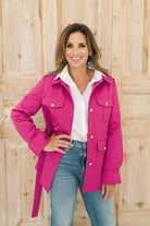 Women's belted jacket is a beautiful berry pink color with orange lining and gold buttons.