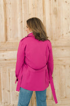 Women's belted jacket is a beautiful berry pink color with orange lining and gold buttons.