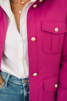 Women's belted jacket is a beautiful berry pink color with orange lining and gold buttons.