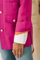 Women's belted jacket is a beautiful berry pink color with orange lining and gold buttons.