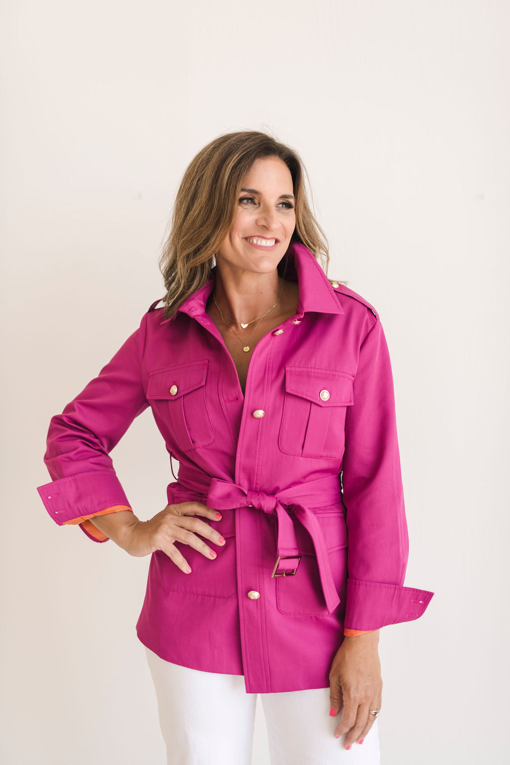 Women's belted jacket is a beautiful berry pink color with orange lining and gold buttons.