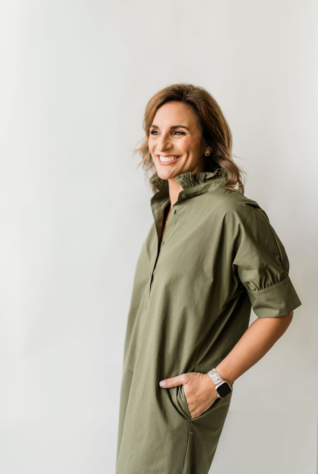 Long olive green button down dress with short sleeves, ruffle collar and pockets.
