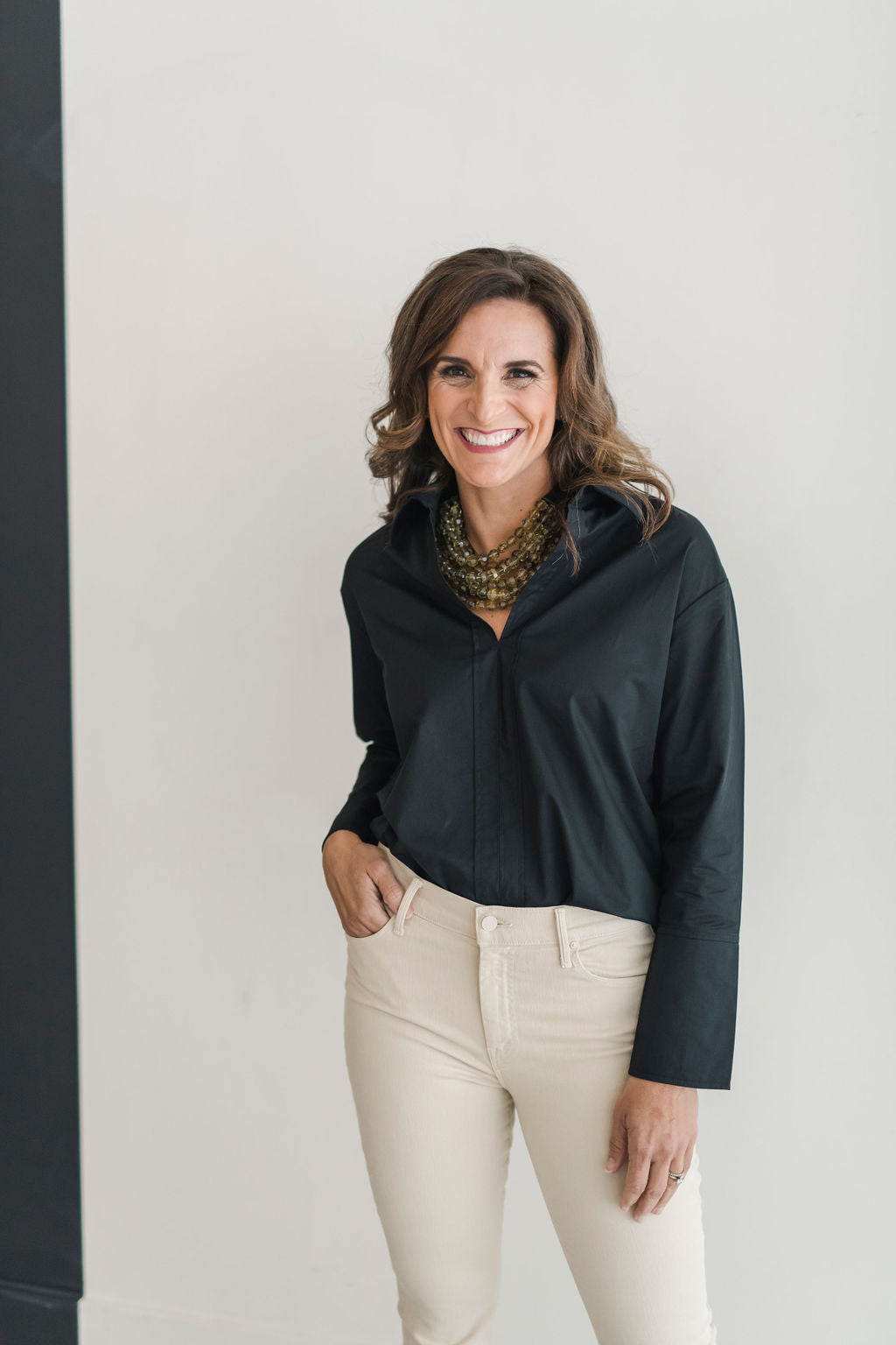 Black, crisp long sleeve shirt with a popped collar, pullover style.