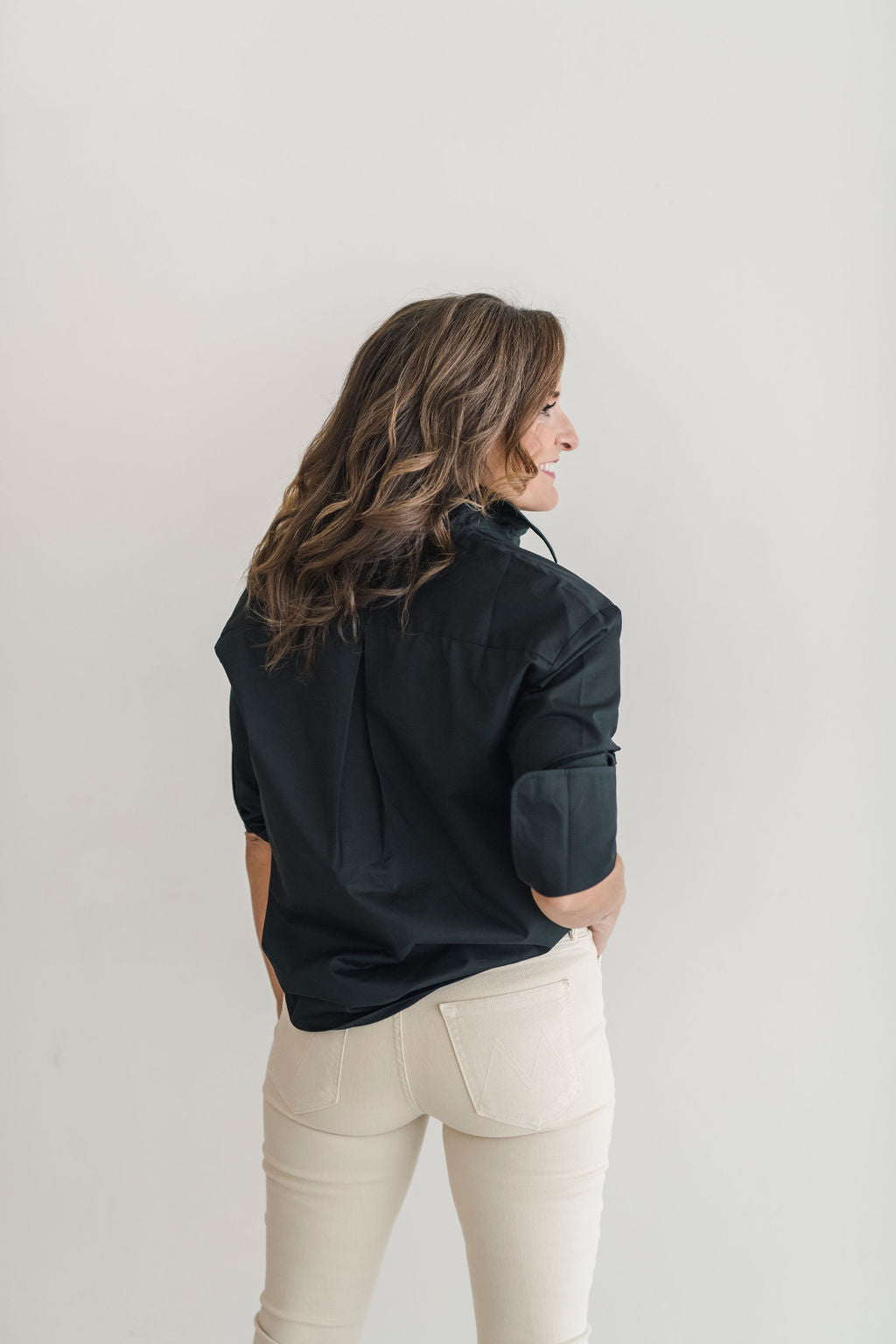 Black, crisp long sleeve shirt with a popped collar, pullover style.