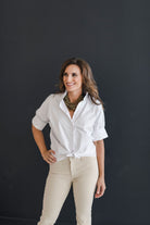 Crisp white short sleeve shirt with a fun ruffle collar.