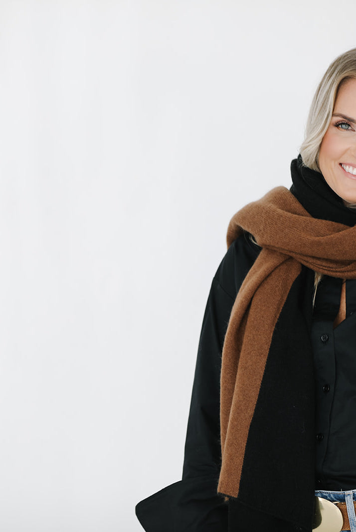 Woman wearing a black and brown scarf on a white background