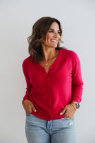 Woman wearing fuchsia pink 100% cashmere cardigan.