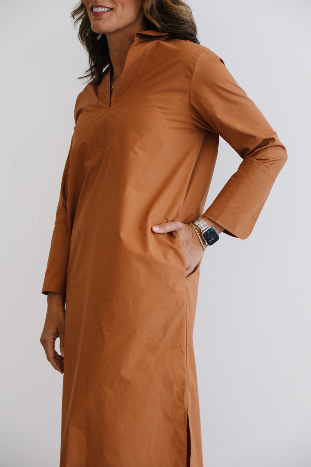 Woman wearing a brown dress with a white background