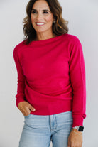 Woman wearing fuchsia pink 100% cashmere cardigan.