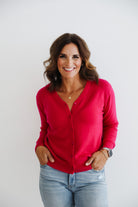 Woman wearing fuchsia pink 100% cashmere cardigan.