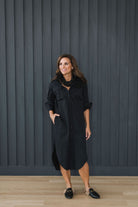 Crisp and classic black button down shirt dress. Mid length, pockets, popped collar.