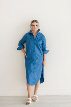 Button down shirt dress in a beautiful blue hue.  Features pockets and a popable collar.