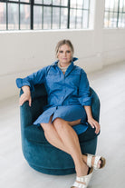 Button down shirt dress in a beautiful blue hue.  Features pockets and a popable collar. Paired casually with Birkenstocks.