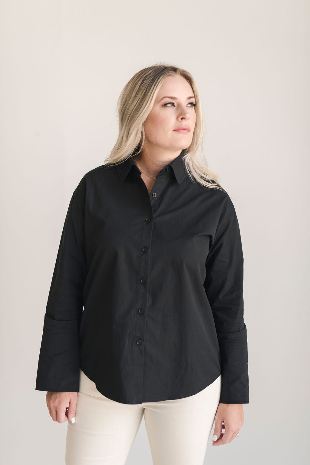 Crisp and classic women's button down shirt in black.