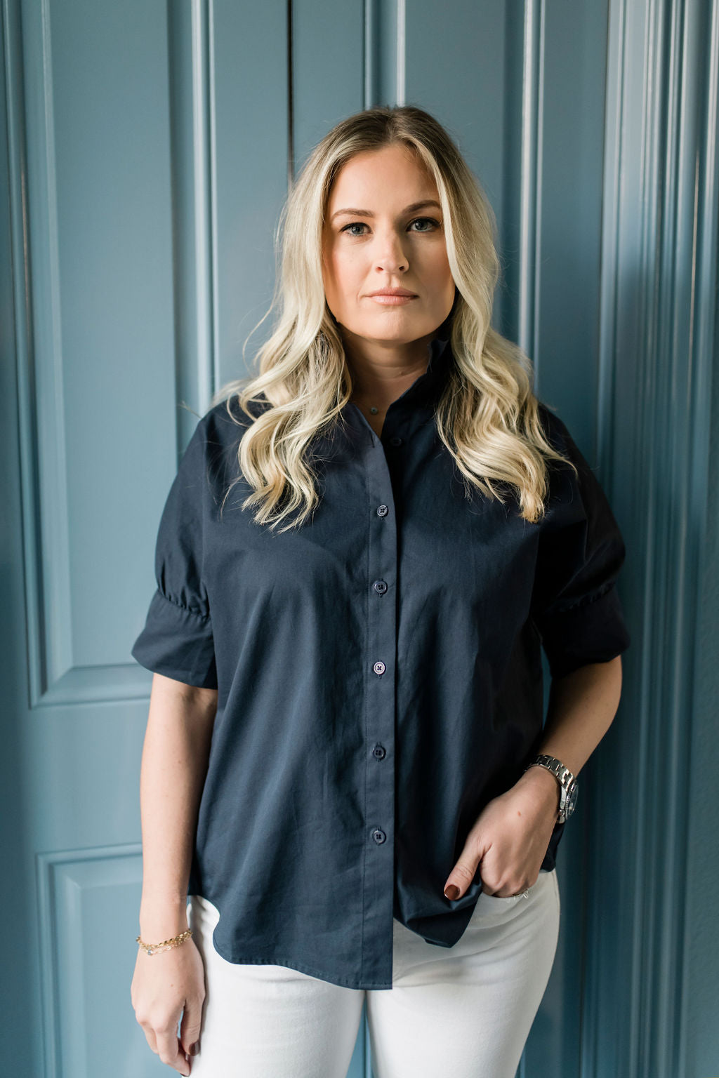 Crisp button down women's shirt with a ruffle collar in Navy blue.