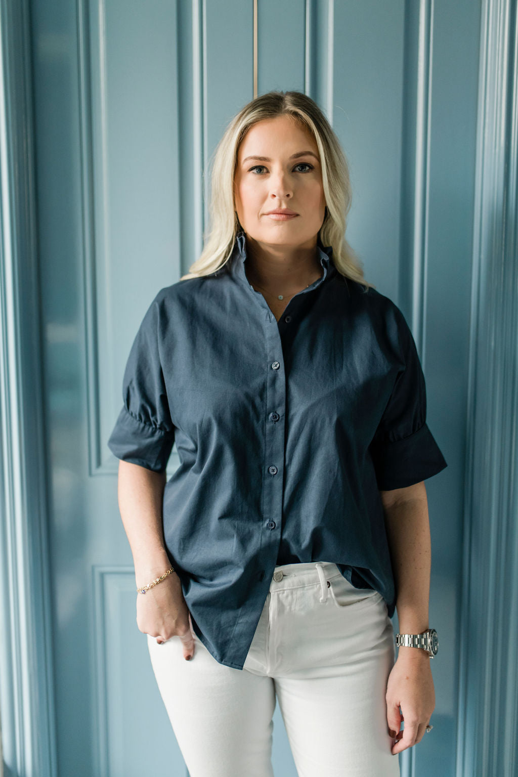 Crisp button down women's shirt with a ruffle collar in Navy blue.