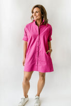 Berry pink women's button down dress with short sleeves and a ruffle collar.