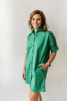 Women's short button down dress with short sleeves and a ruffle collar in green.