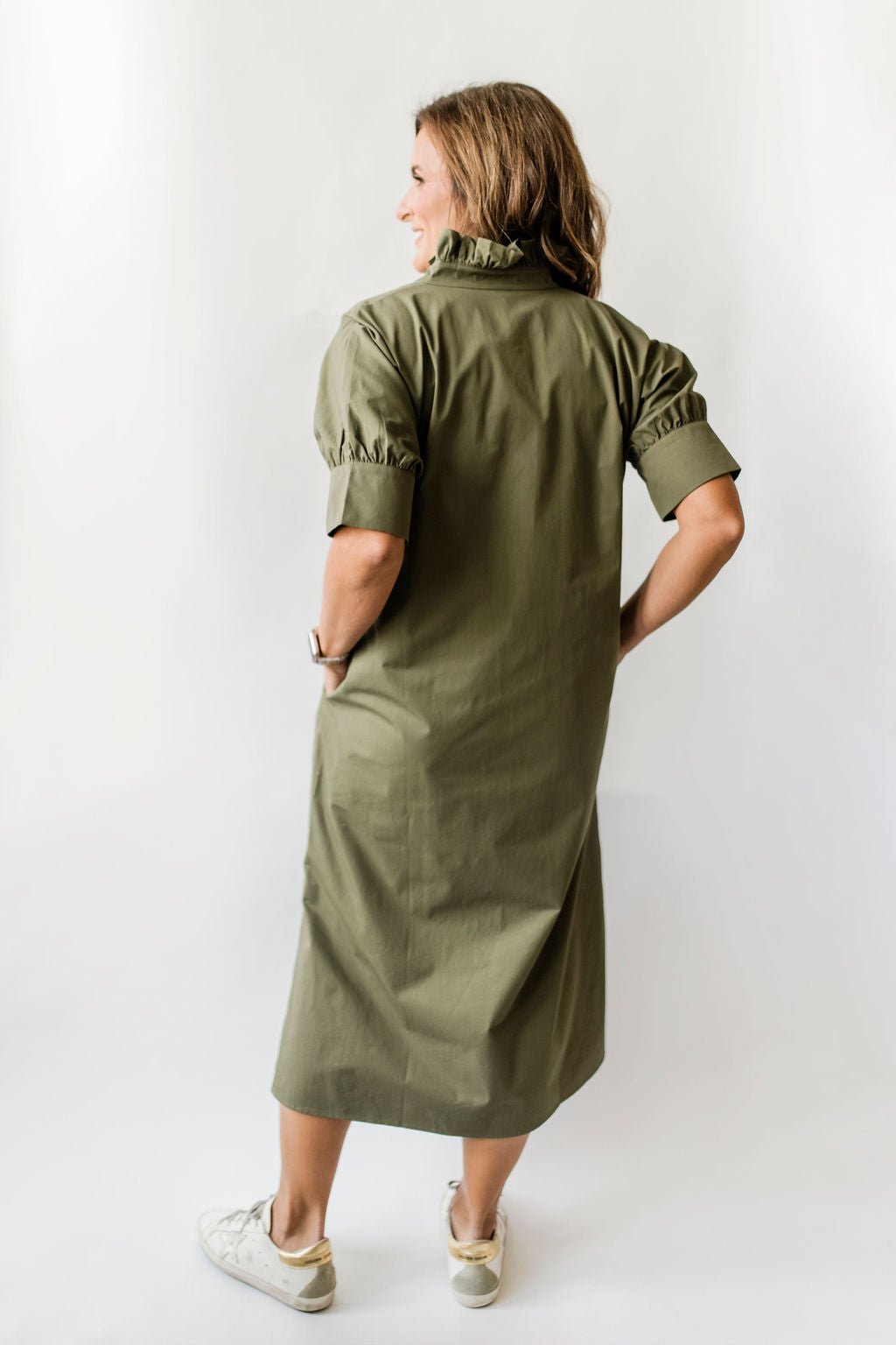 Long olive green button down dress with short sleeves, ruffle collar and pockets.