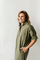 Long olive green button down dress with short sleeves, ruffle collar and pockets.