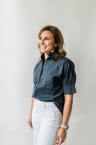 Crisp button down women's shirt with a ruffle collar in Navy blue.