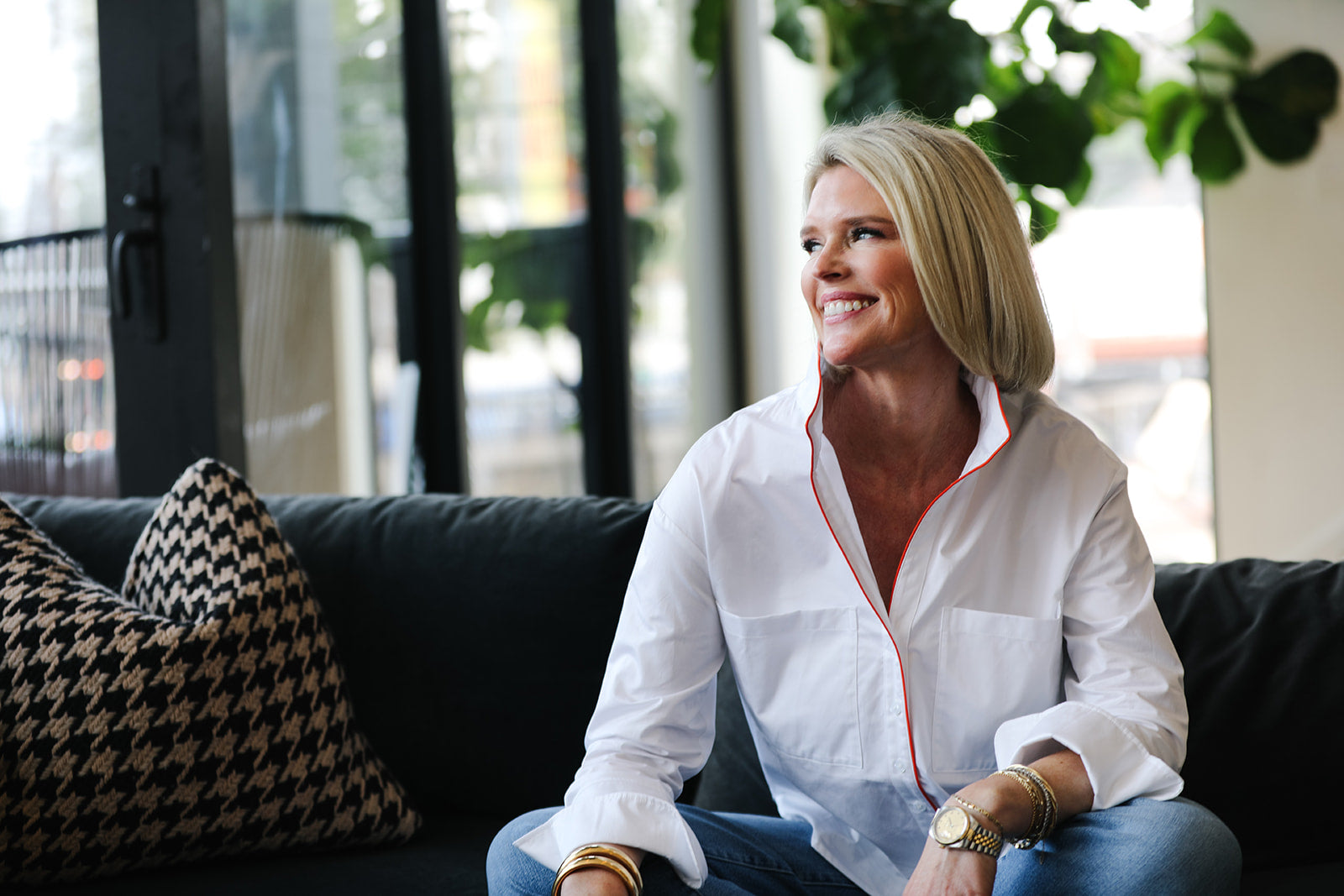 Woman sitting on a couch in a modern living room