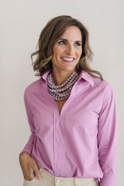 Lilac color, crisp long sleeve shirt with a popped collar, pullover style.