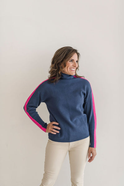A cozy navy and pink colorblocked turtleneck sweater.