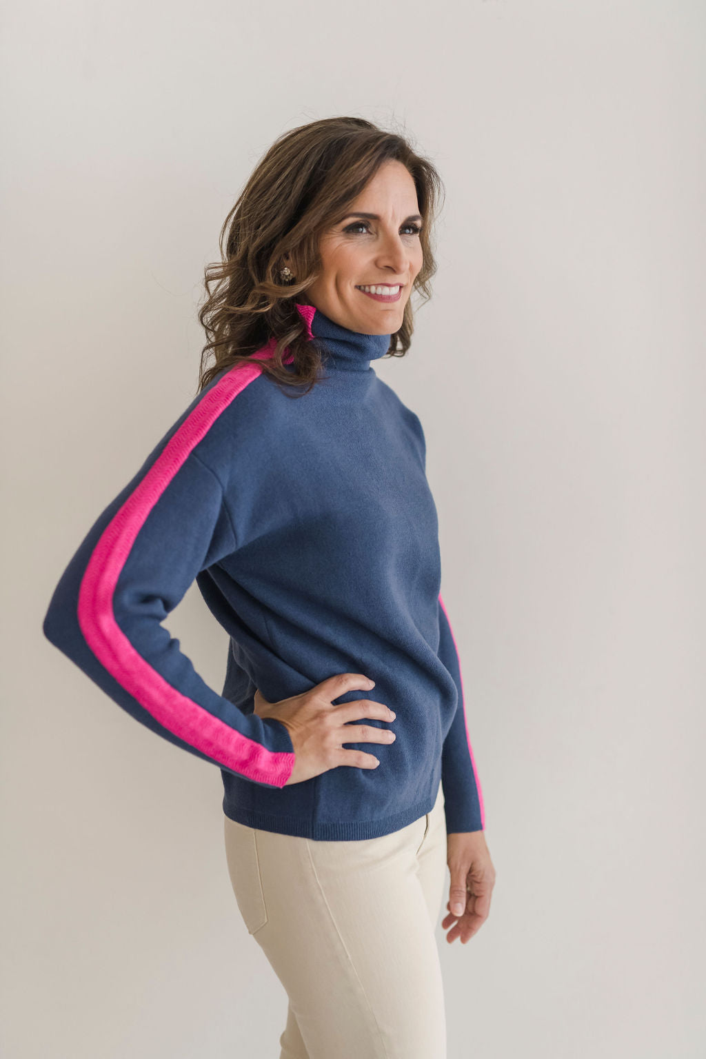 A cozy navy and pink colorblocked turtleneck sweater.