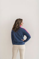 A cozy navy and pink colorblocked turtleneck sweater.