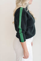 A cozy black and green color blocked turtleneck sweater.