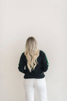 A cozy black and green color blocked turtleneck sweater.