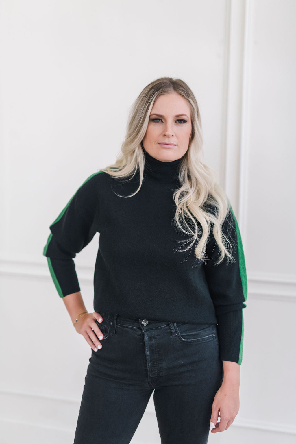 A cozy black and green color blocked turtleneck sweater.