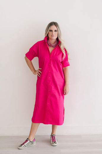 Button down shirt dress in hot pink.  Ruffle collar with elbow length sleeves.