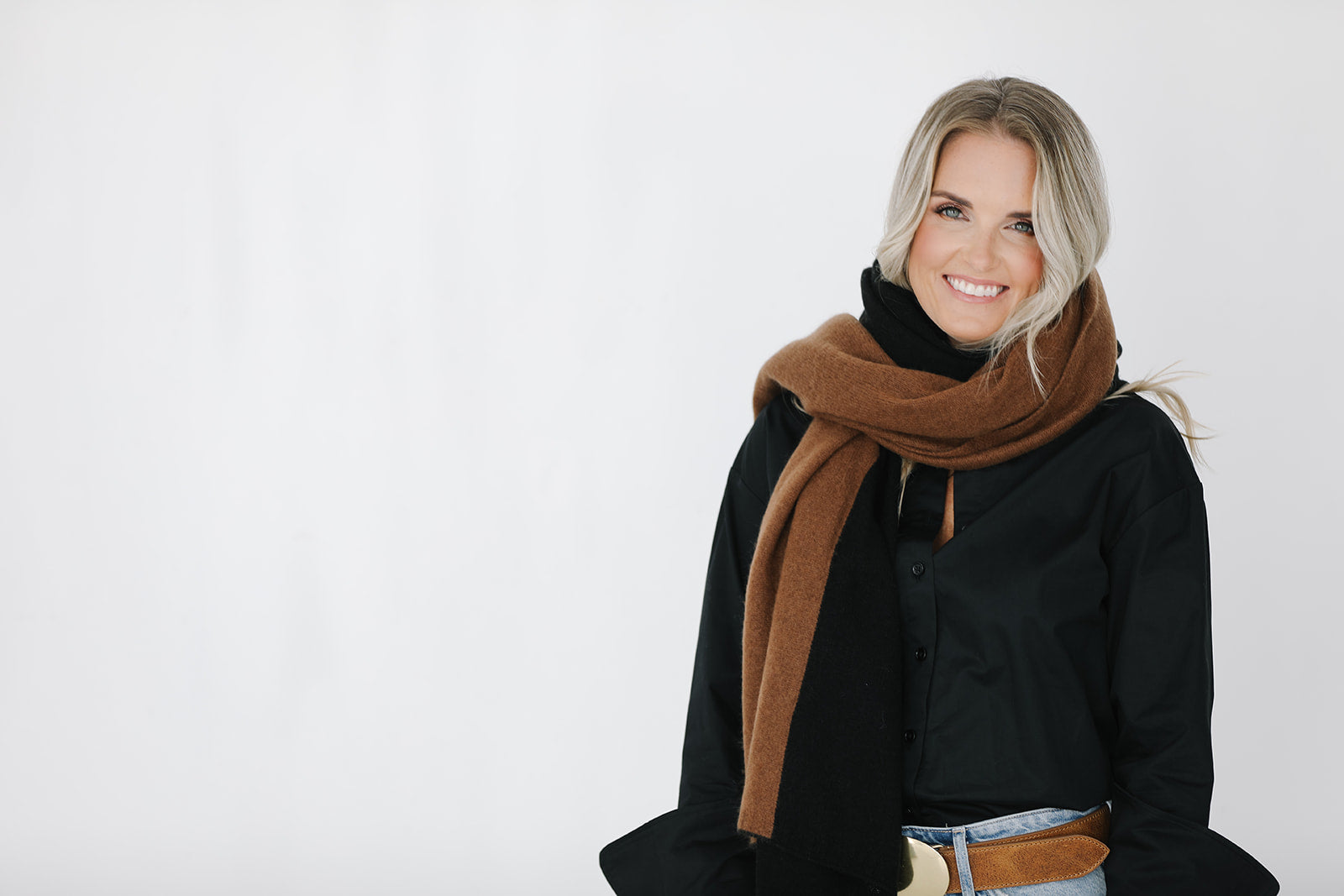 Woman wearing a black and brown scarf on a white background