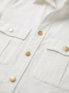Close-up of a white jacket with gold buttons